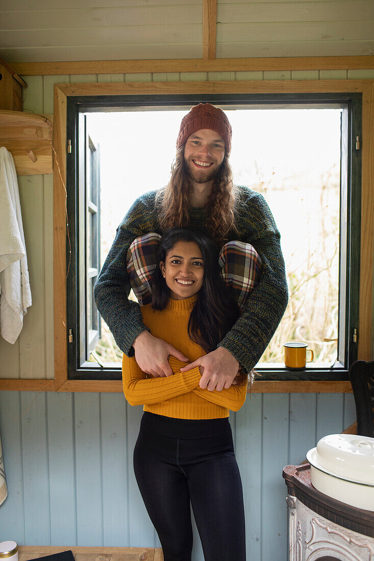 Happy young couple in cabin window
