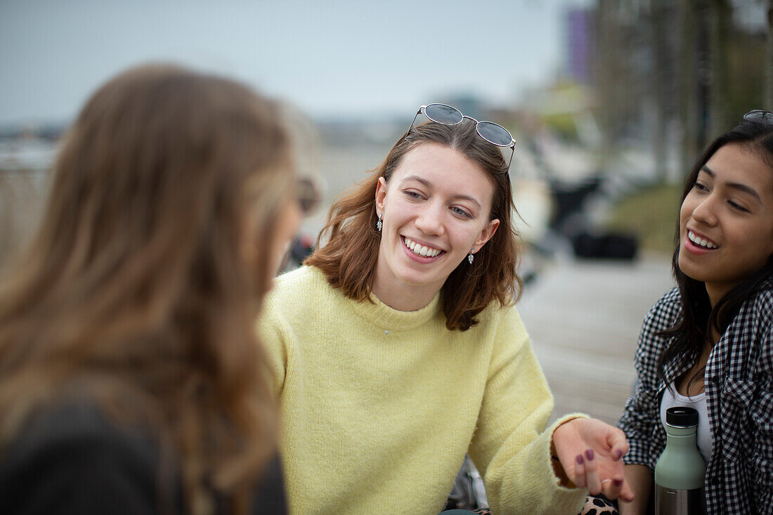 Happy young female friends talking