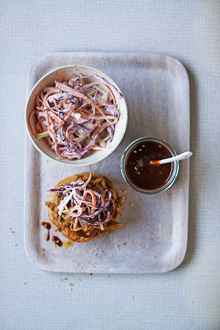 Ariel shot of Pulled pork burger without top of bun homemade chipolte molasses BBQ Sauce and Tangy cabbage slaw