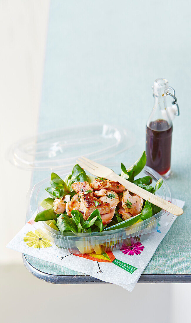 Salmon salad with a honey dressing in a take away container