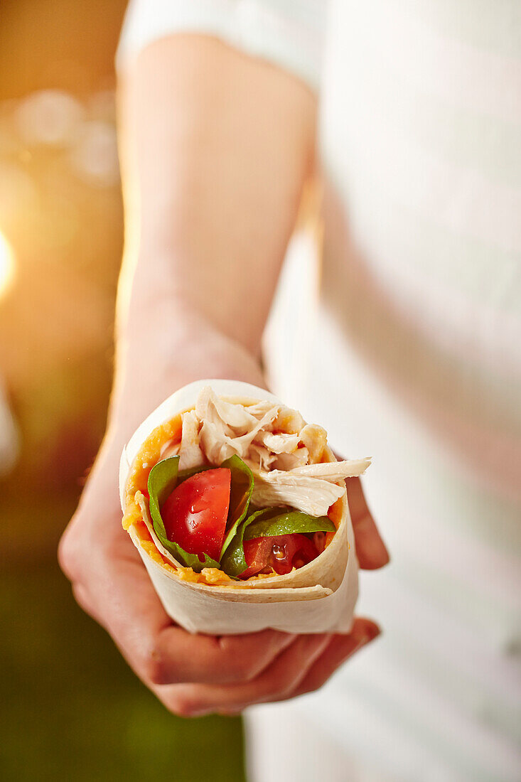 Chicken wrap with sticky sweet potato, salad leaves and tomatoes