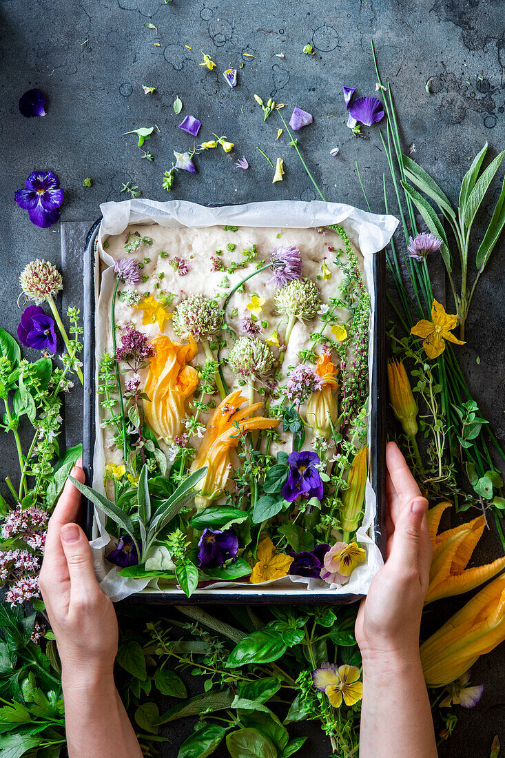 Raw garden foccacia with herbs and edible flowers