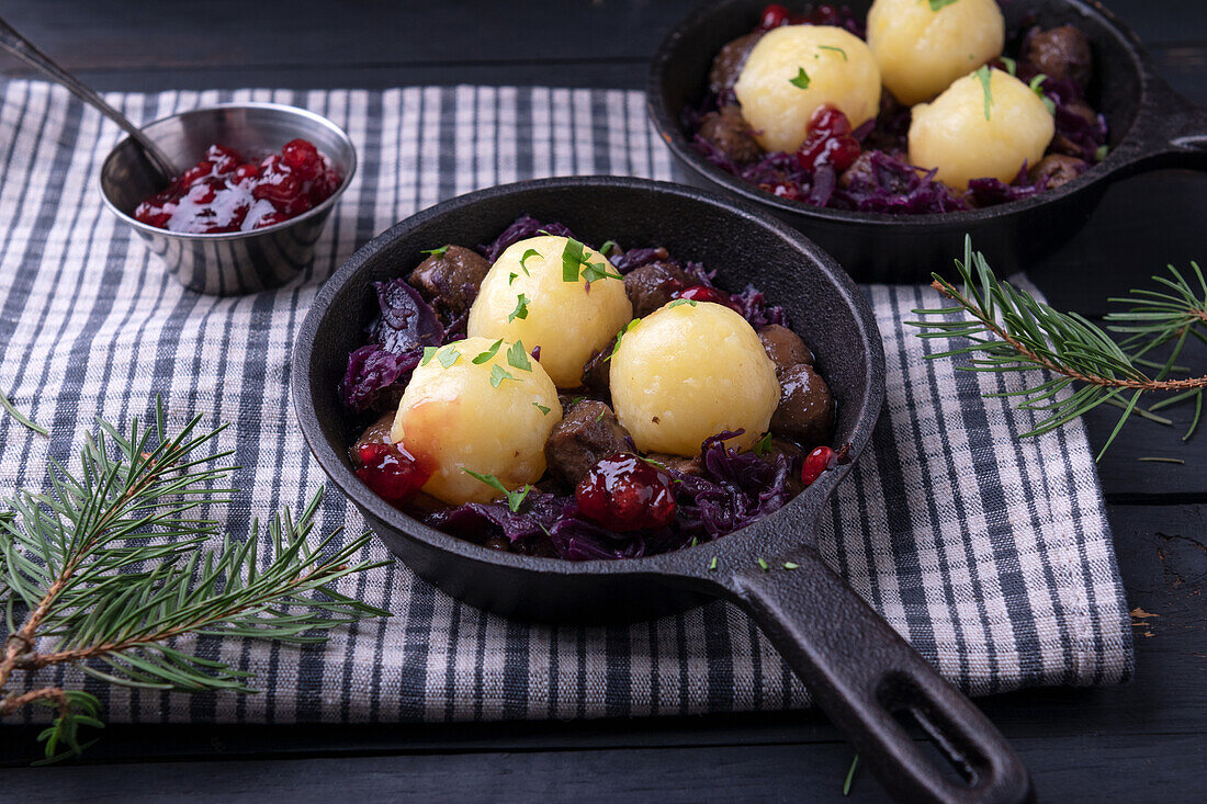 Vegan soy goulash with red cabbage, potato dumplings and cranberries