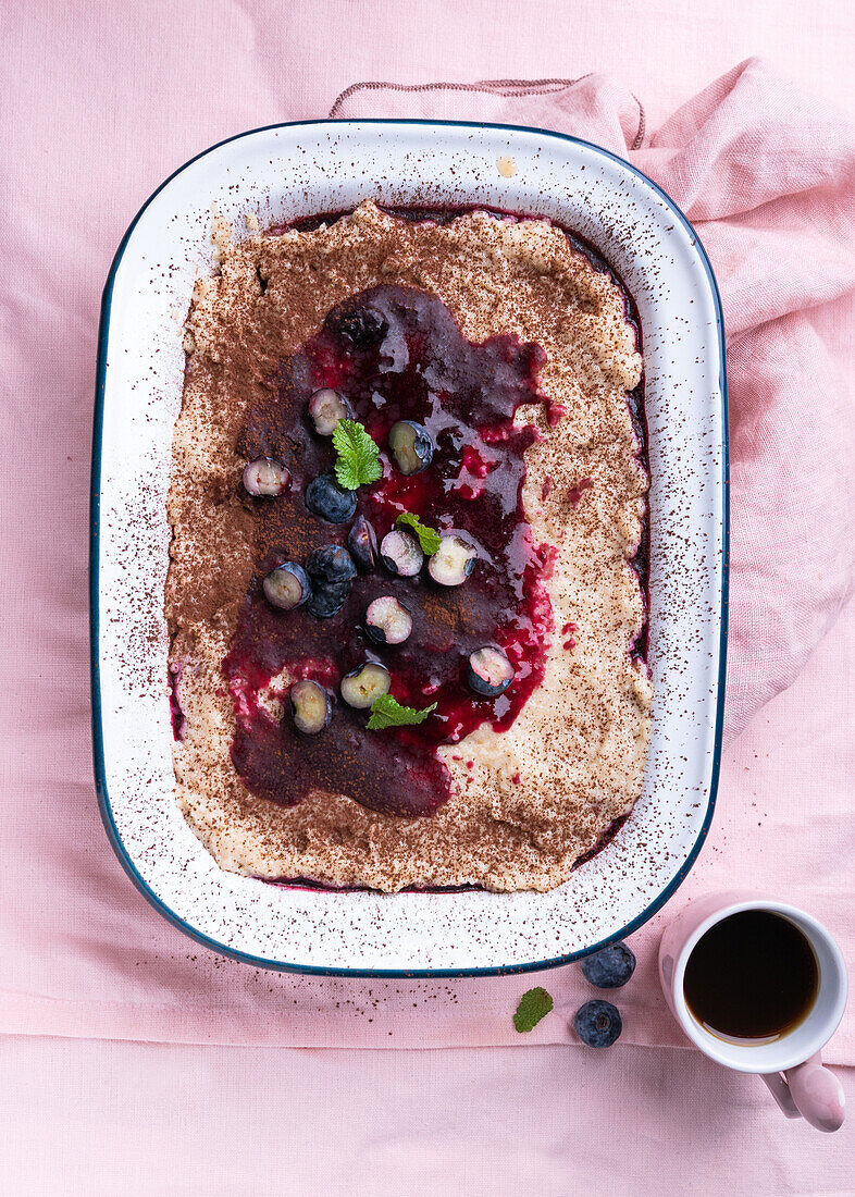 Vegan layered dessert of almond sponge cake, semolina cream and blueberries