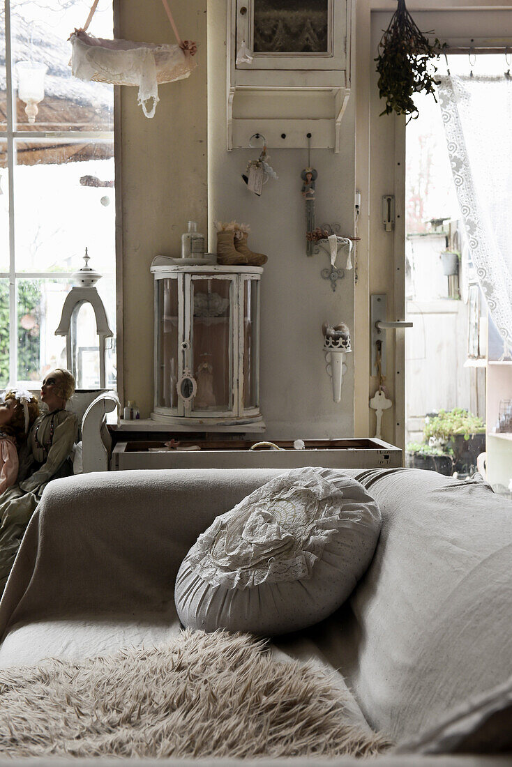 Sofa with light-colored upholstery, animal fur, and romantic cushion