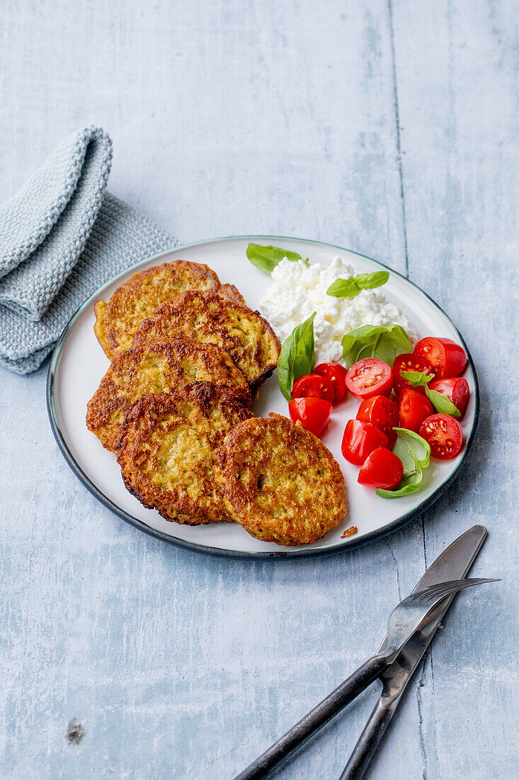 Vegetable pancakes with tomatoes and grainy cream cheese