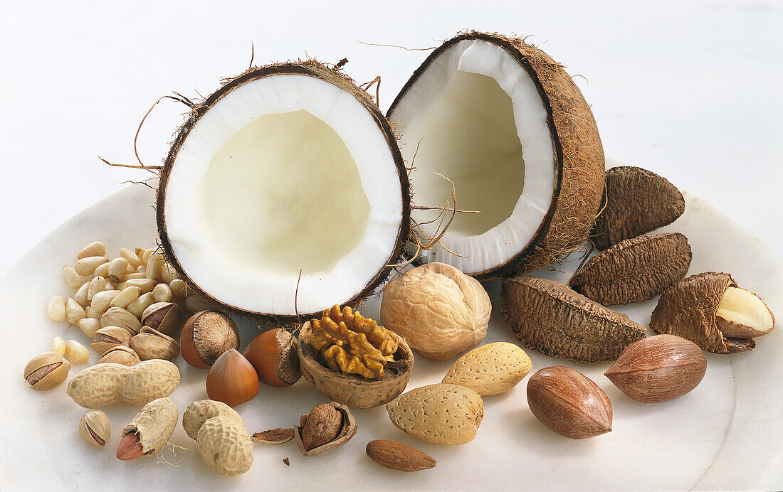 Halved coconut with various nuts
