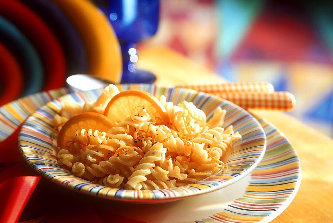 Pasta (fusilli) with oranges in deep plate