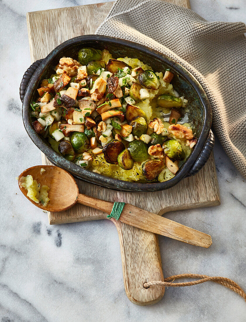 Vegan Brussels sprouts and potato casserole with pear-walnut sprinkle