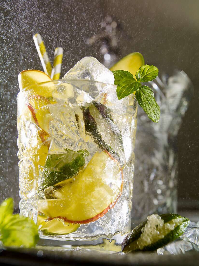 Sparkling drink with gin, mango and finger limes (lime pearls)