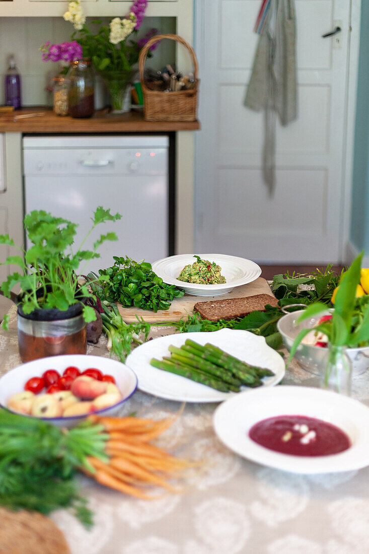 Vegetables and herbs on a kitchen table