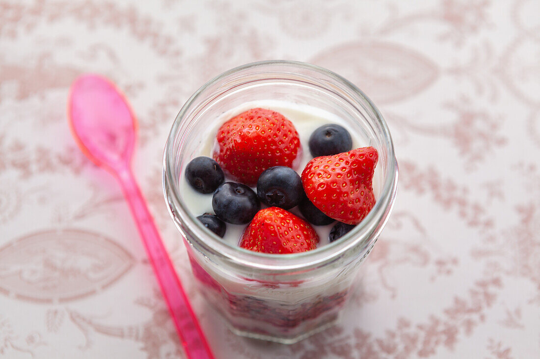 Yoghurt with granola, strawberries, raspberries and blueberries
