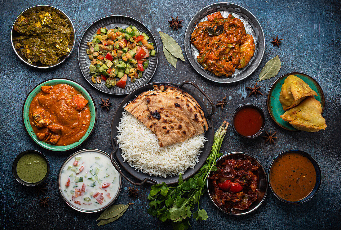 Assorted Indian ethnic food buffet on rustic concrete