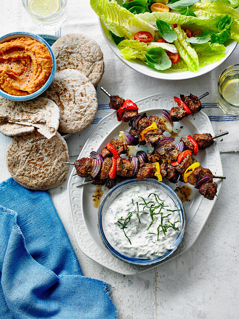 Lamb souvlaki with tzatziki, pita and salad