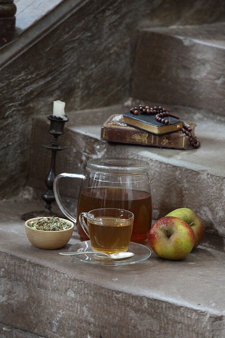 Tea and apples (monastic fasting), candlestick, Bible, and rosary