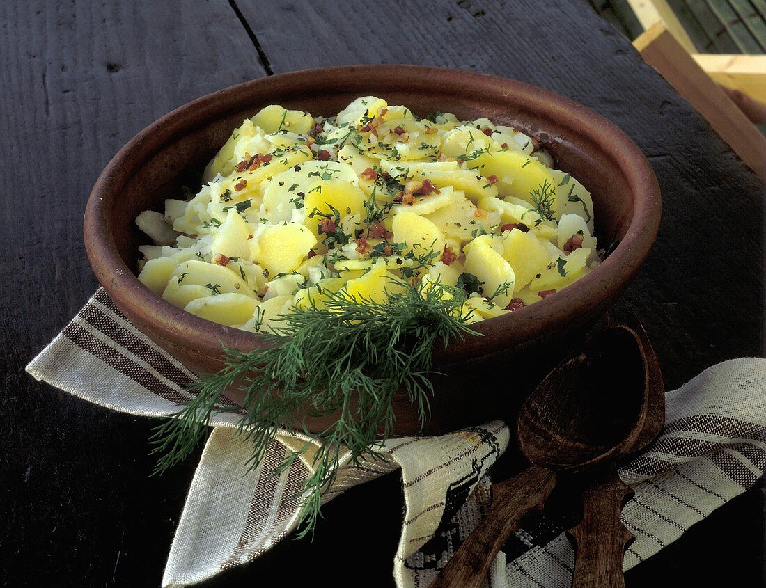 Potato salad with bacon & dill in stoneware bowl