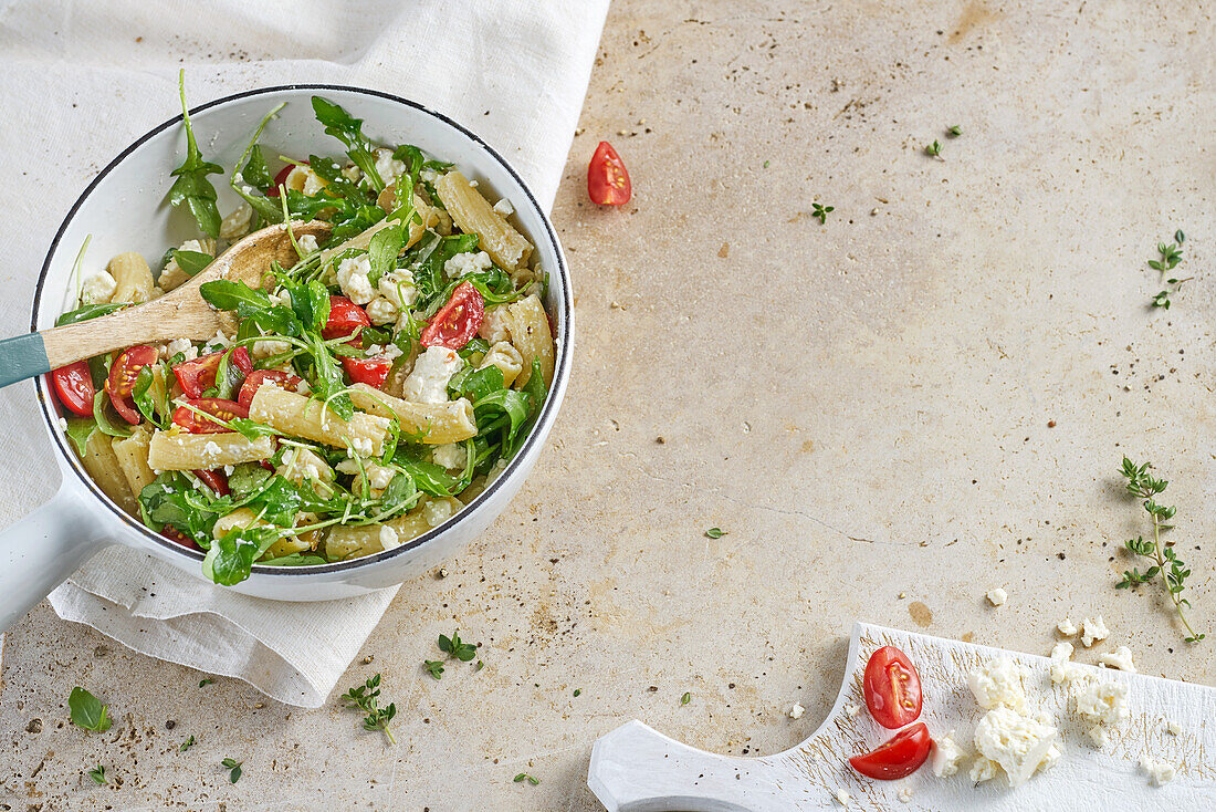 Mediterranean pasta salad with rocket, cherry tomatoes, feta, and thyme