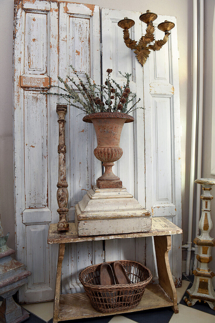Urn vase in front of old white cupboard