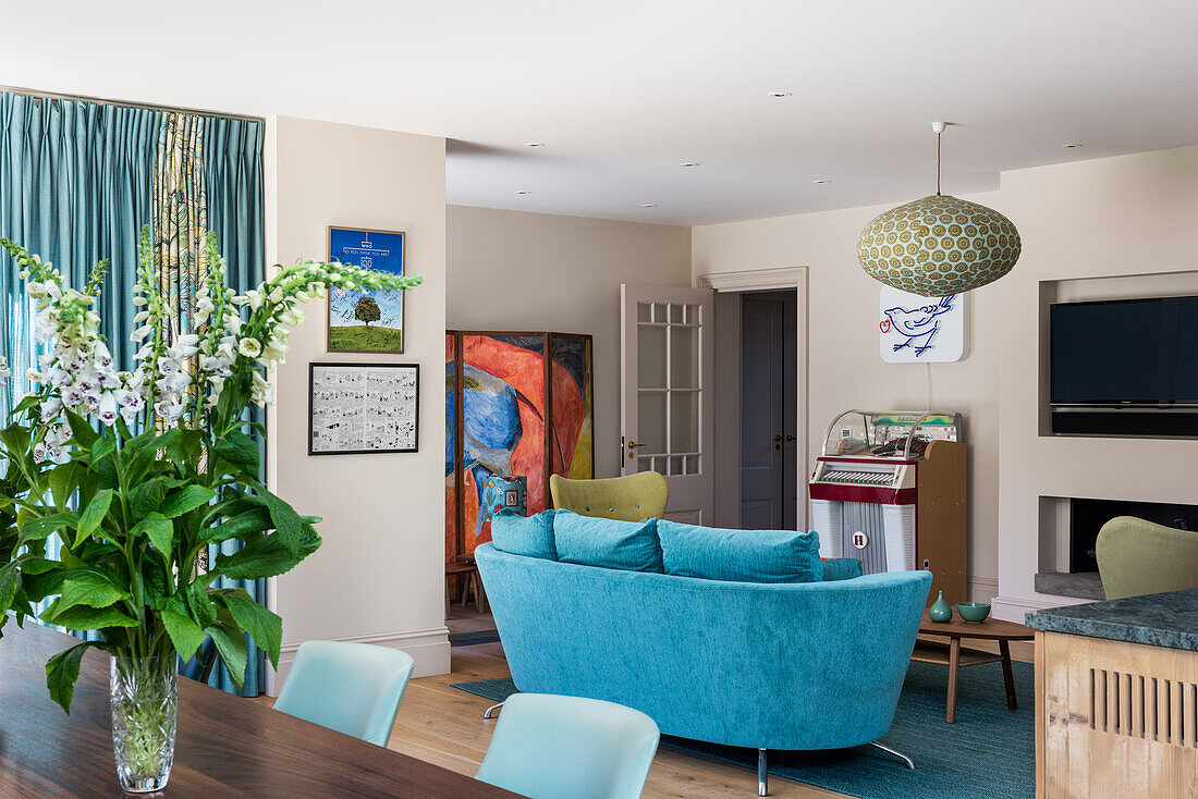 Living room with blue sofa and retro jukebox