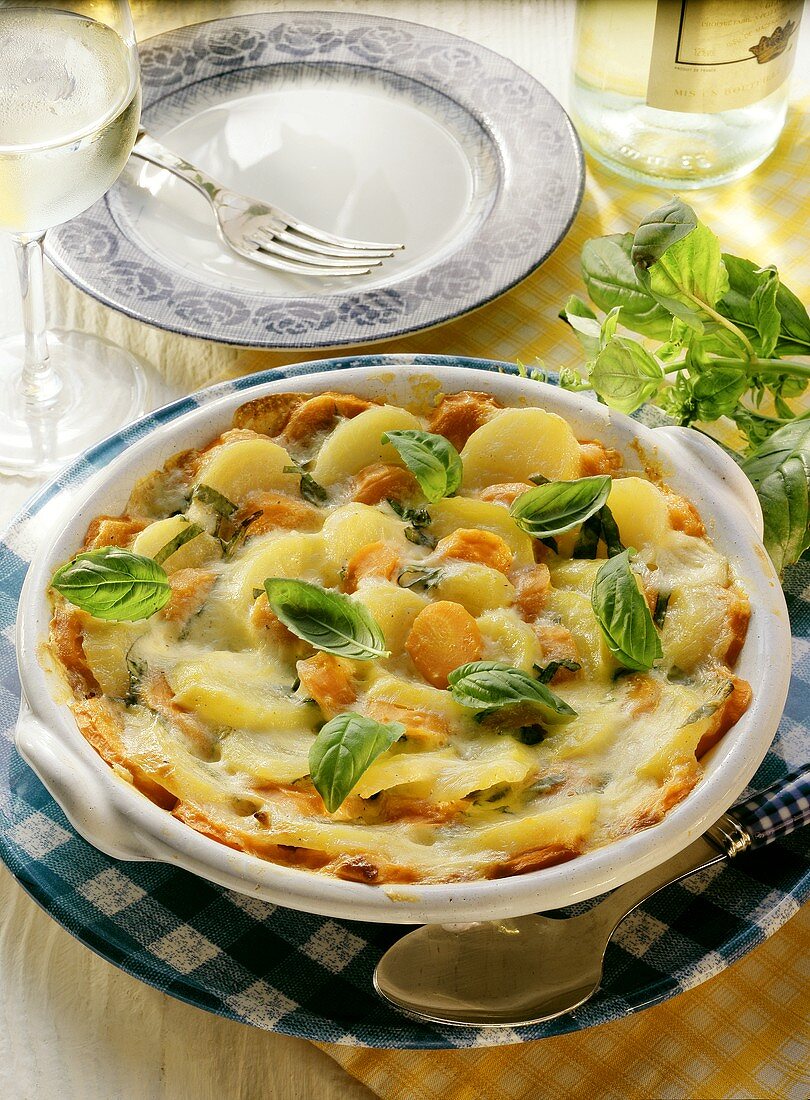 Carrot and potato gratin, garnished with basil leaves