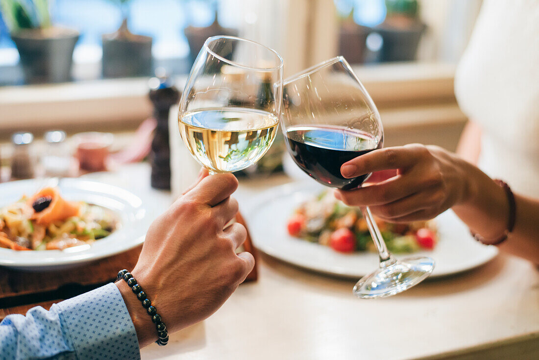 Couple toasting with wine, close-up