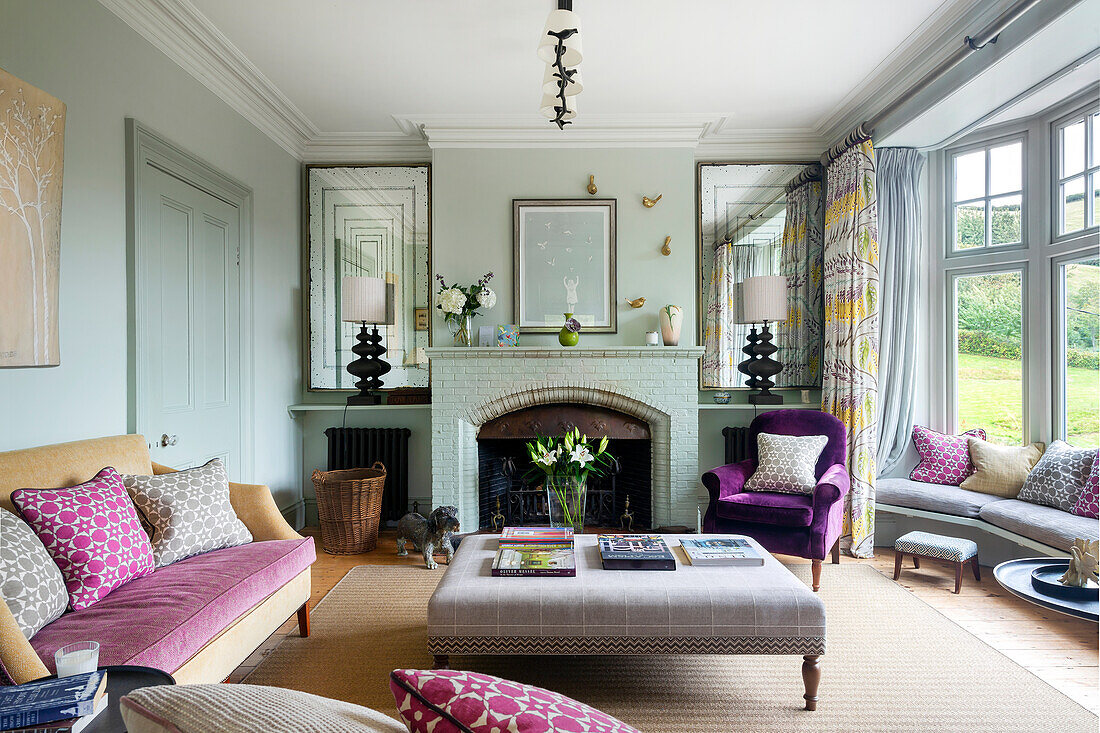 Living room with fireplace, seating and view of the yard