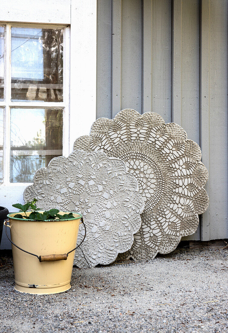 Decorative concrete slabs leaning against house wall