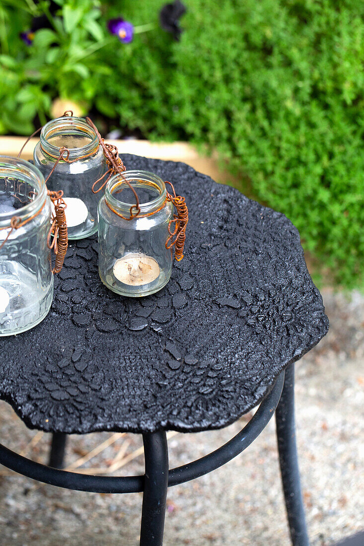 Lanterns on side table with decorative concrete top