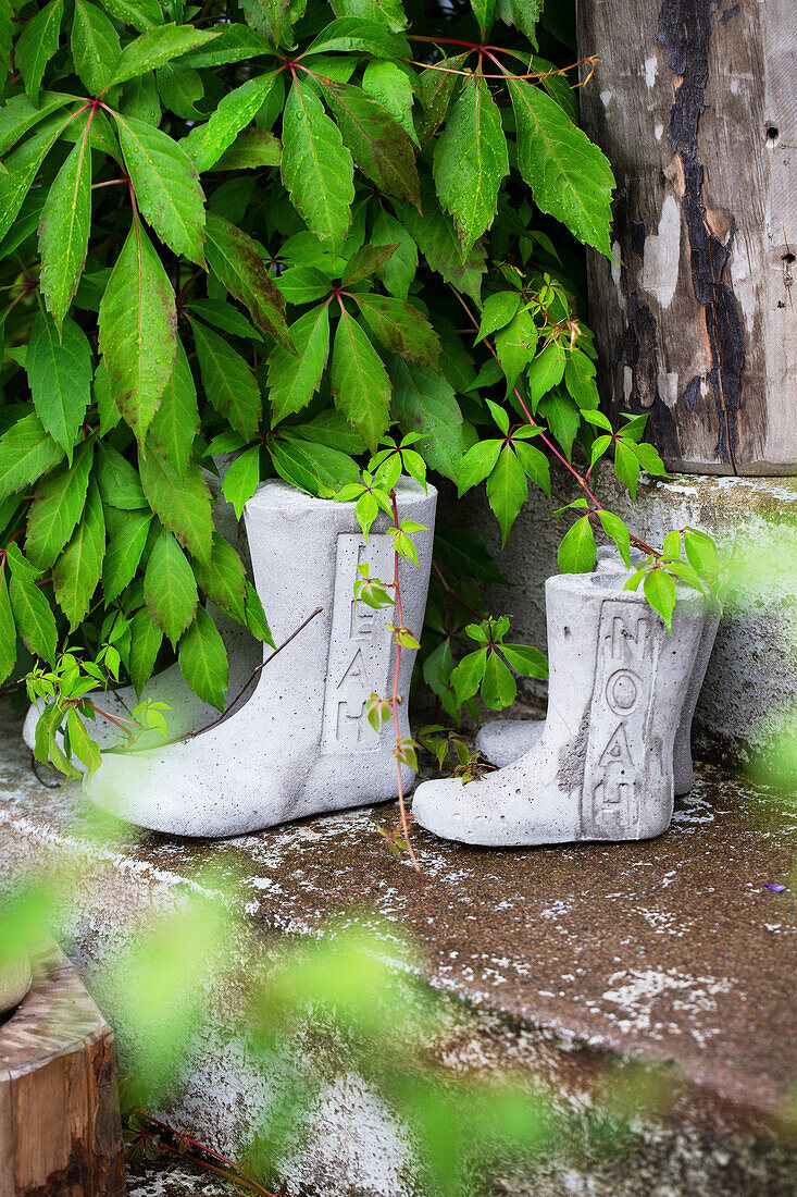 Concrete boots on steps as garden decorations