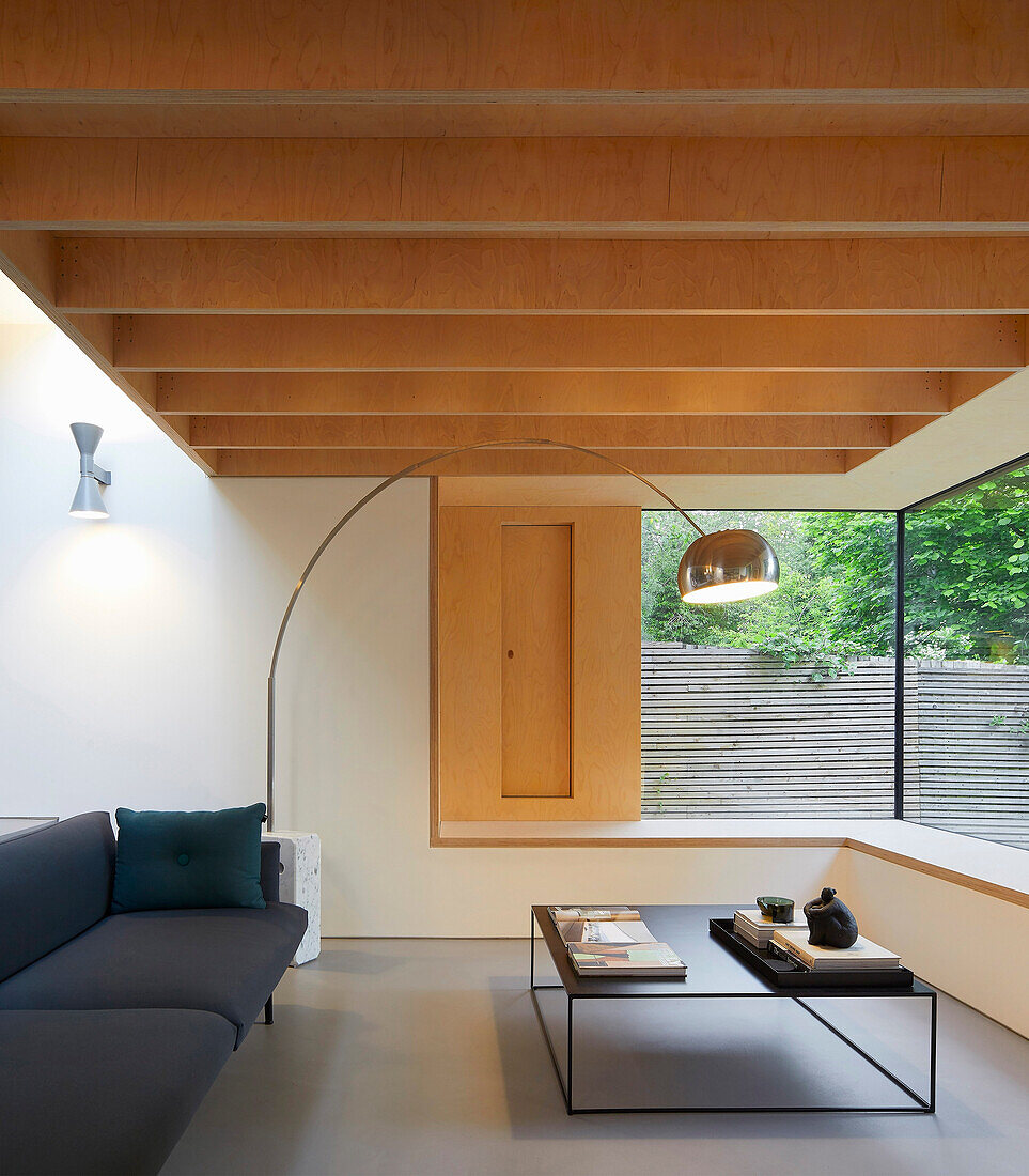 Minimalist living room with wooden ceiling and huge windows