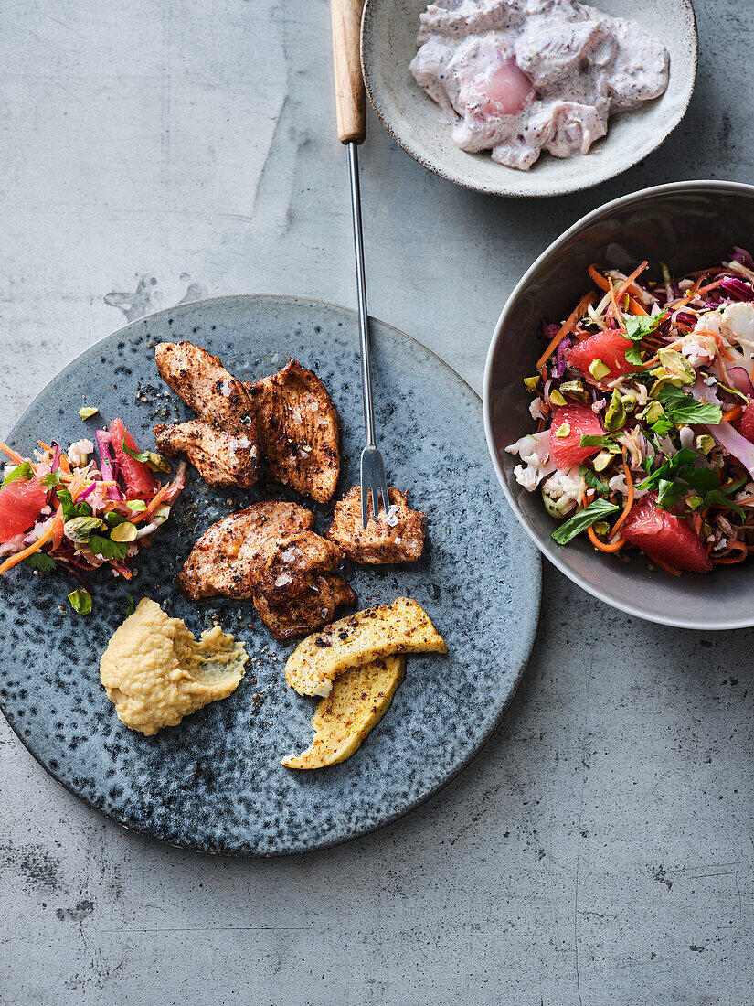 Fondue with yoghurt chicken and colourful oriental slaw