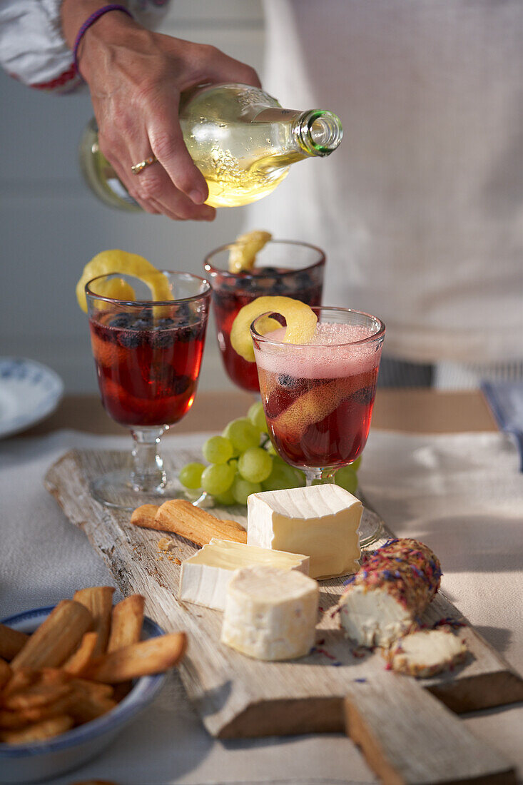 Cheese platter and blueberry-rum cocktail