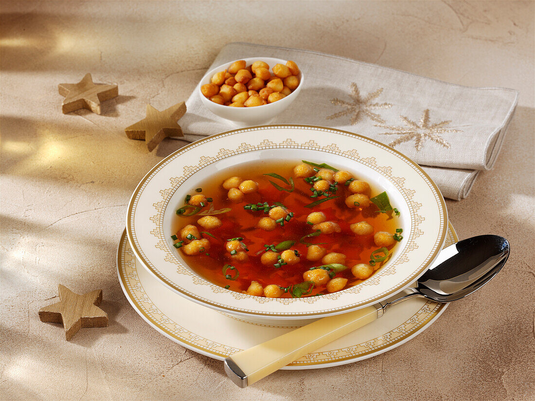 Clear soup with fried batter pearls made with Madeira for Christmas