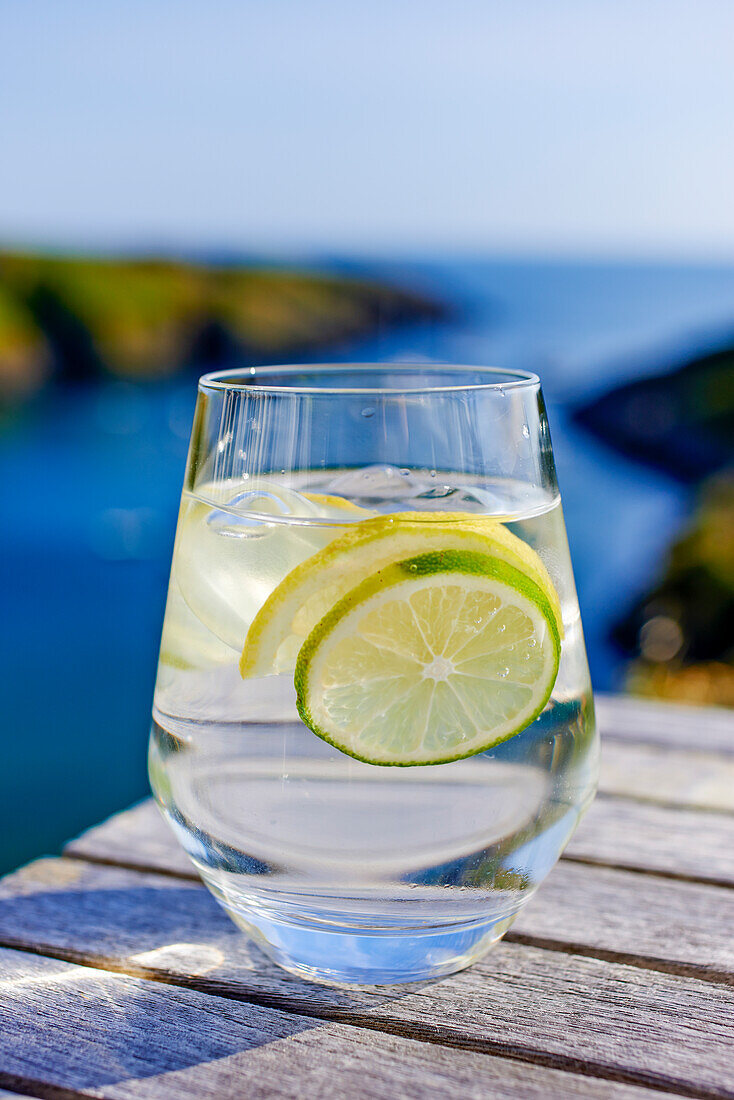 Glass of lemon water on an outdoor table