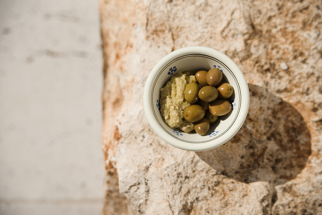 Olive paste and green olives in small bowls