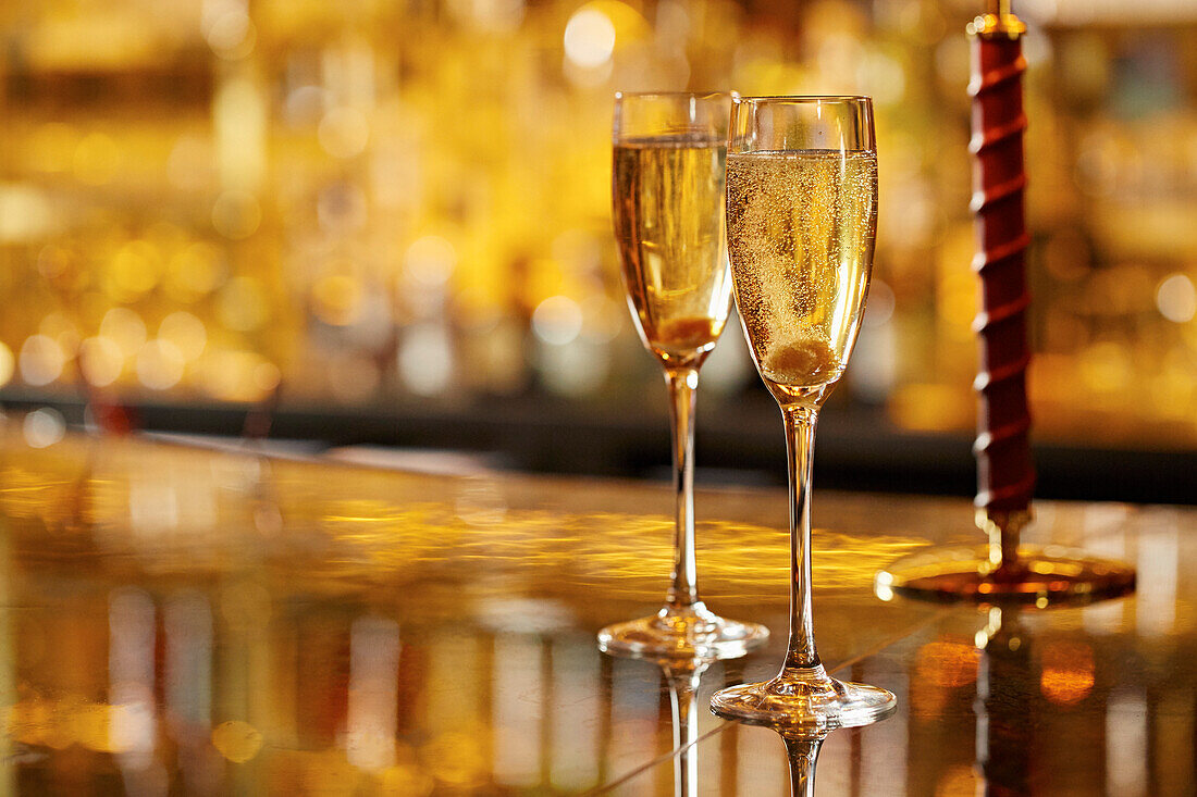 Two champagne cocktails with sugar cubes
