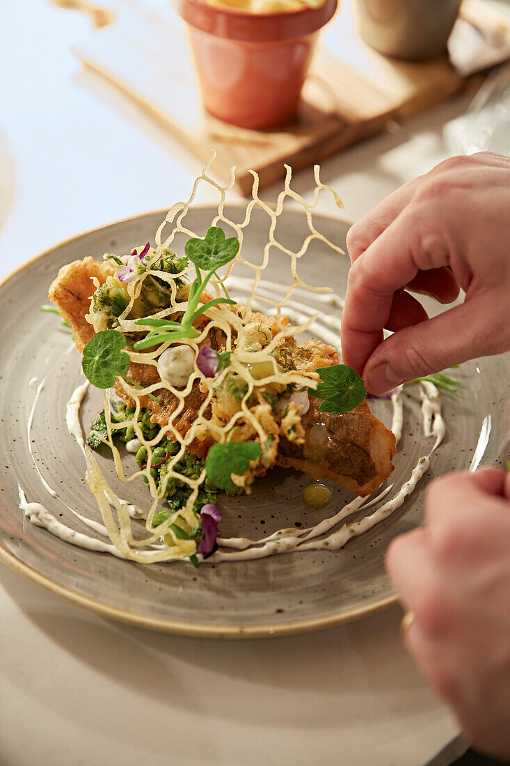 Gebratener Fisch mit Erbsenstampf und Kartoffelgitter