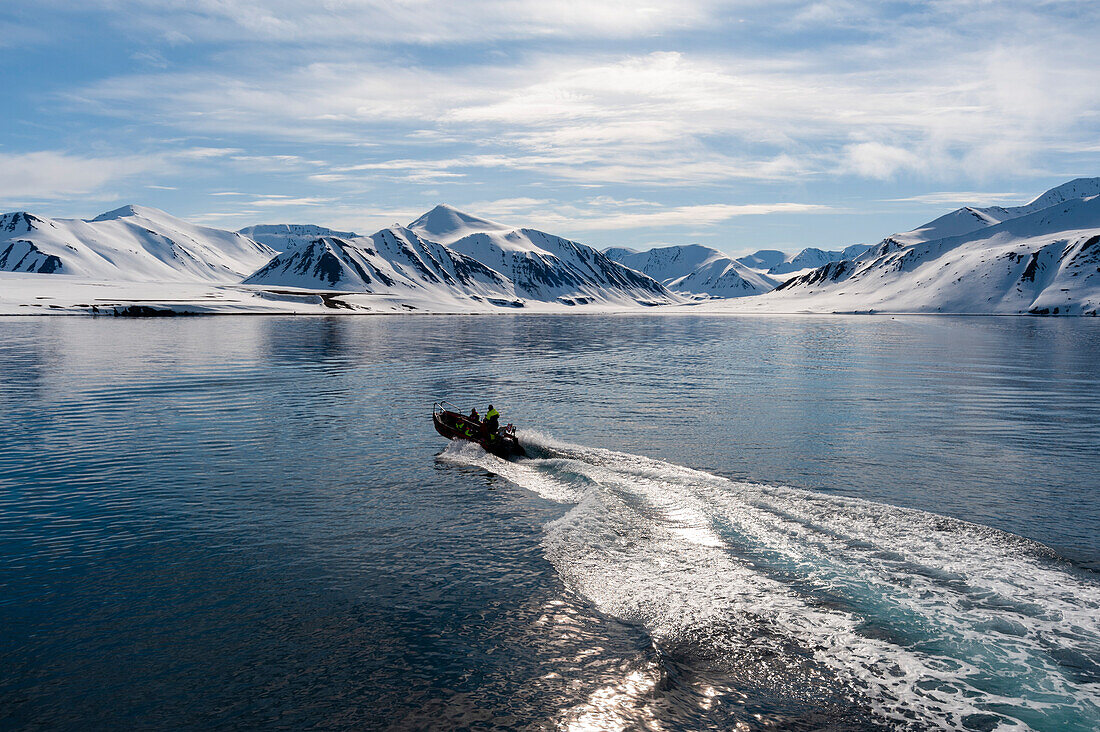 Inflatable raft cruises toward shore on Mushamna Bay, Norway