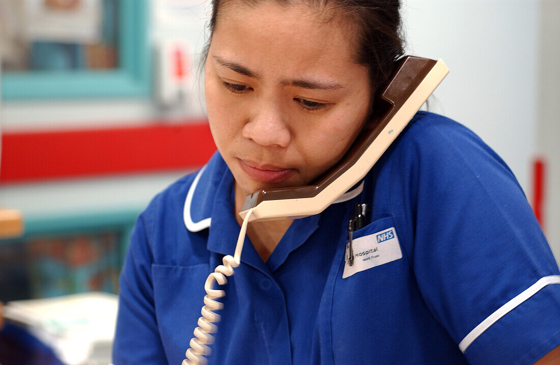 Nurse using hospital telephone