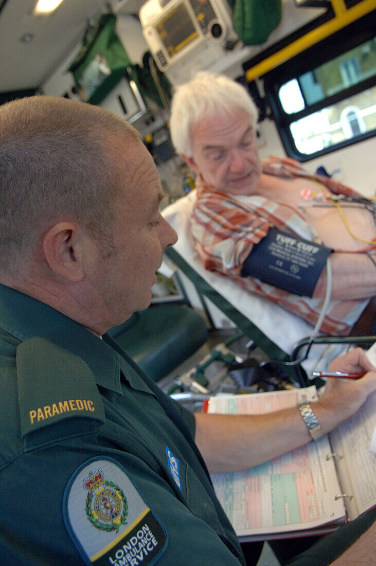 Paramedic taking notes from patient
