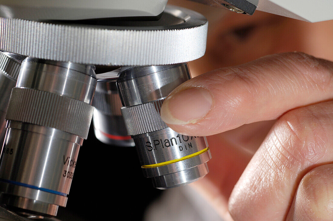 Student adjusting microscope