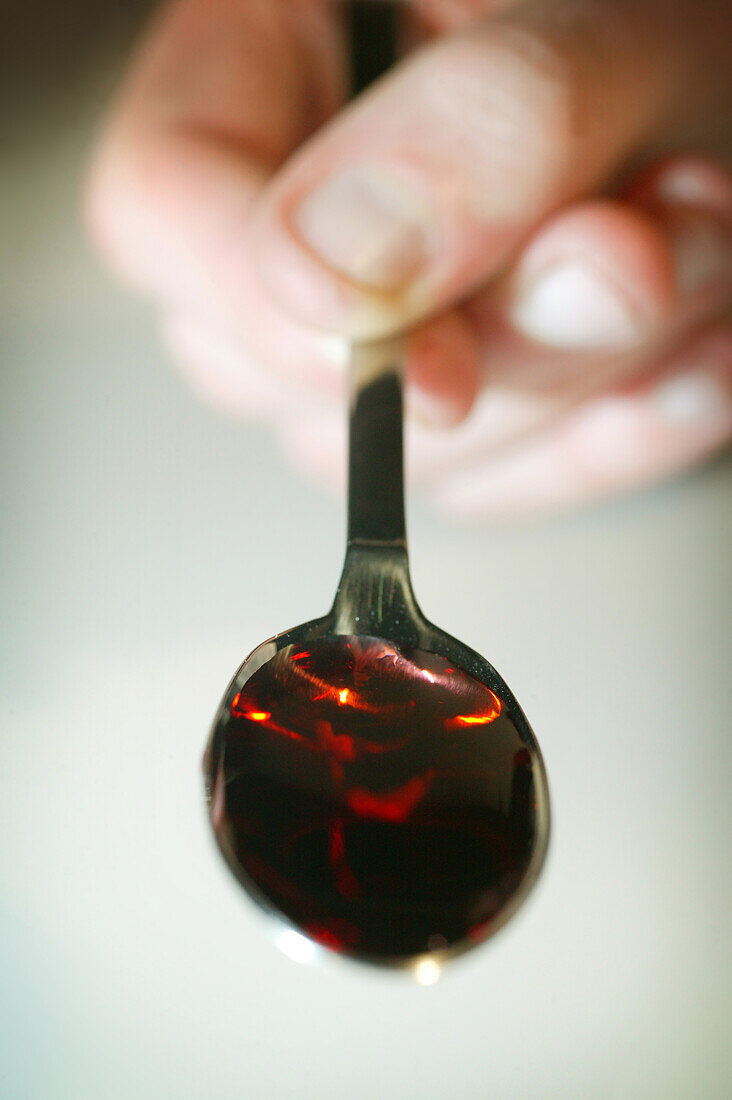 Spoonful of red ibuprofen liquid