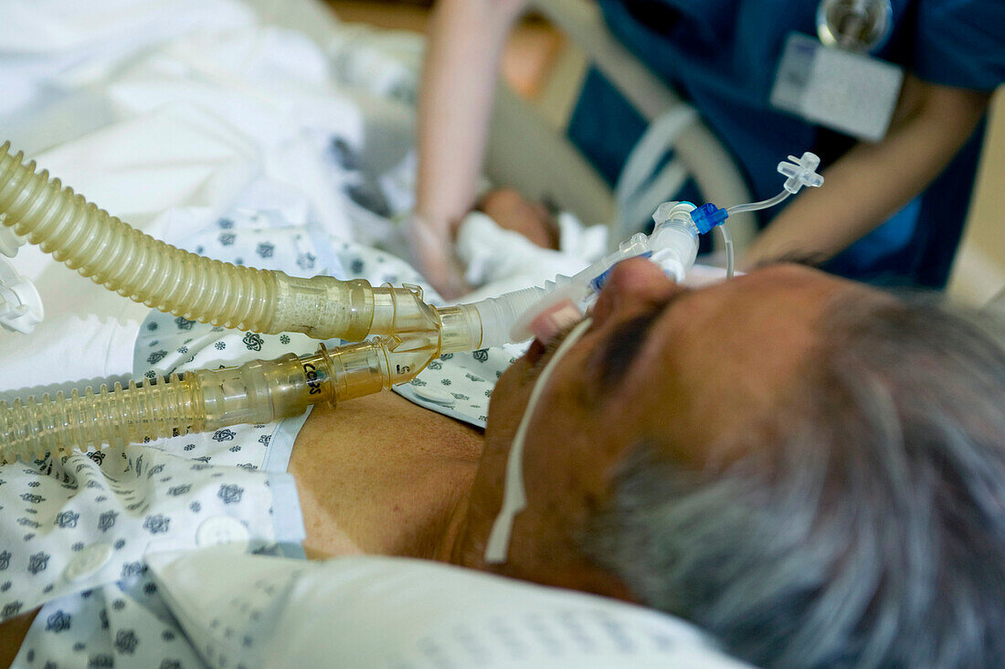 Nurse administers anaesthetic gas to a patient