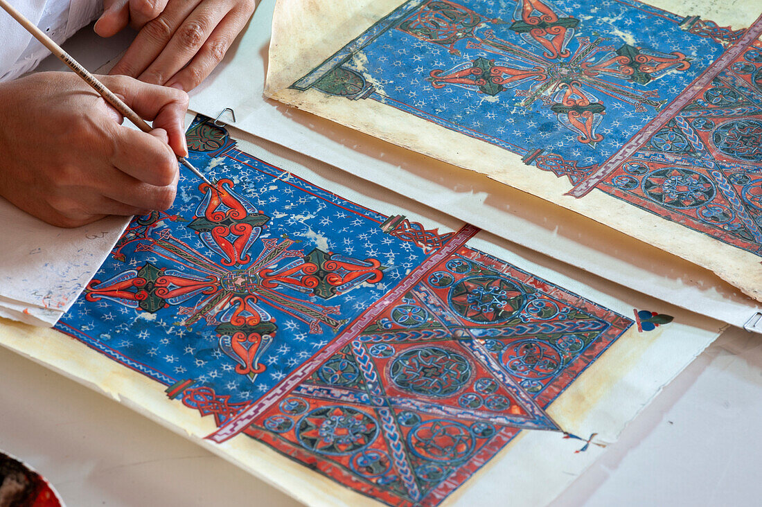 Restorer working on 15th century illustrations