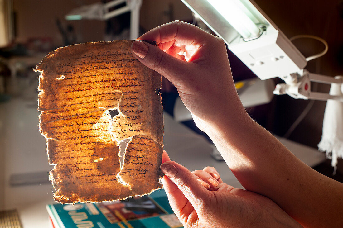 Restorer working on a deteriorated book