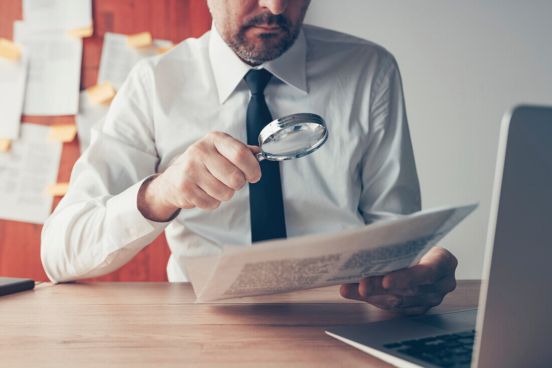 Cautious businessman reading contract