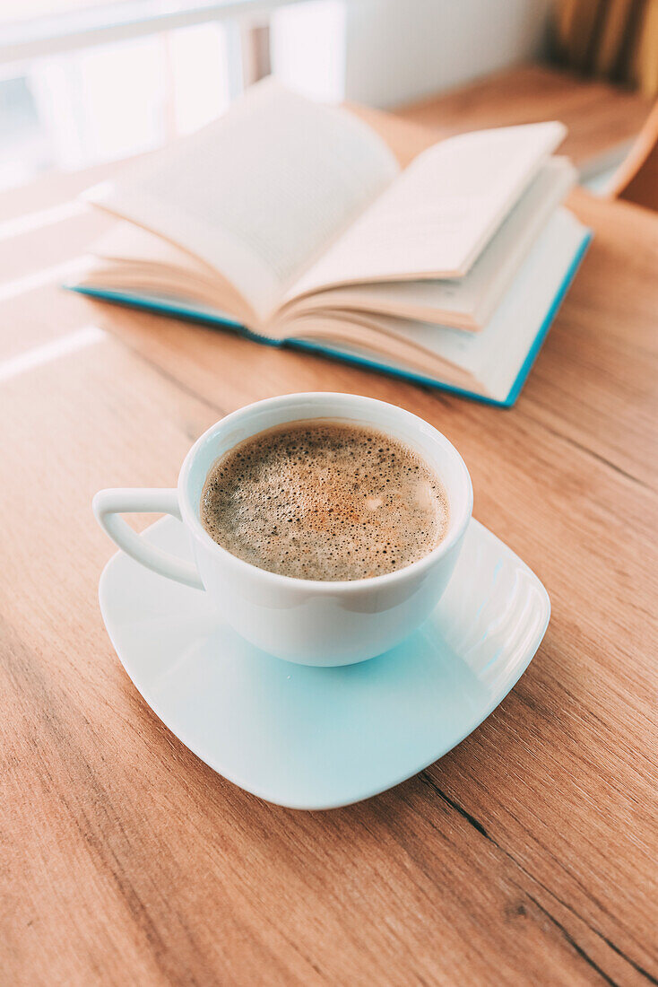 Coffee cup and open book