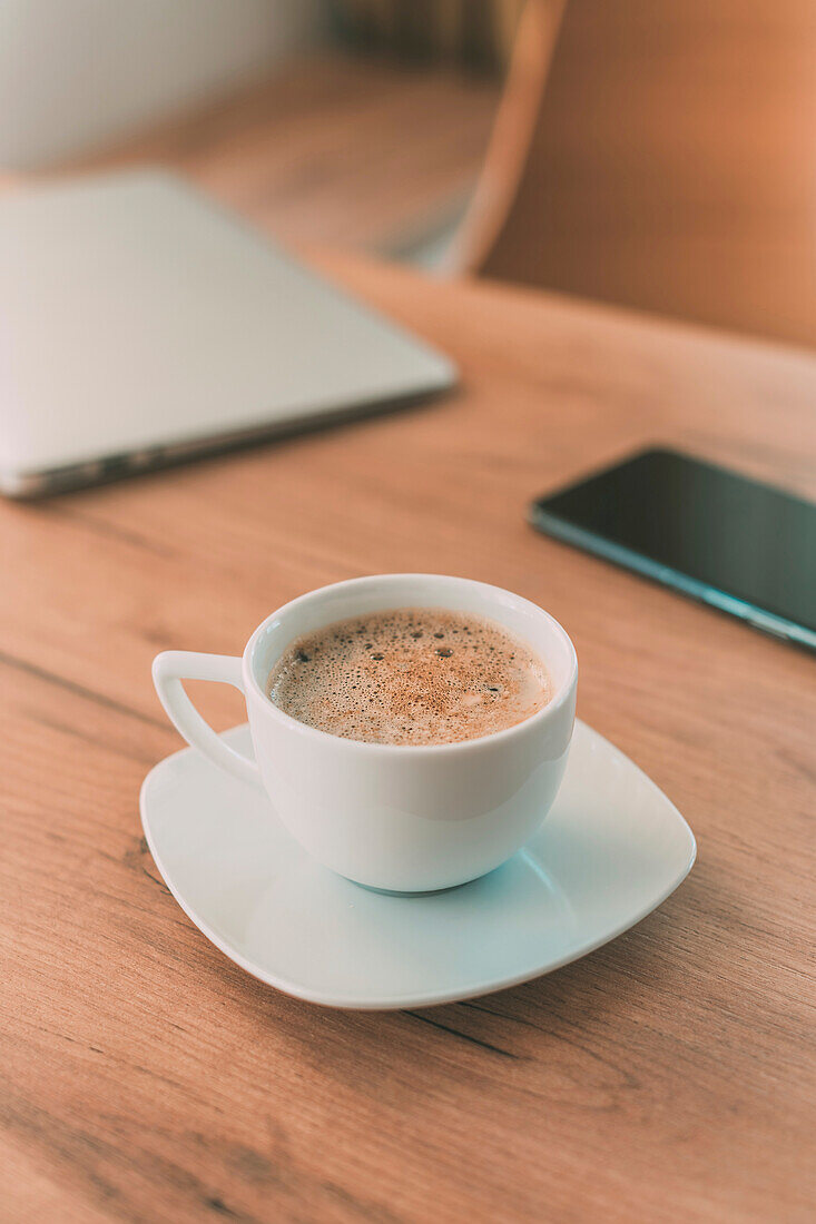 Coffee cup, laptop and smartphone