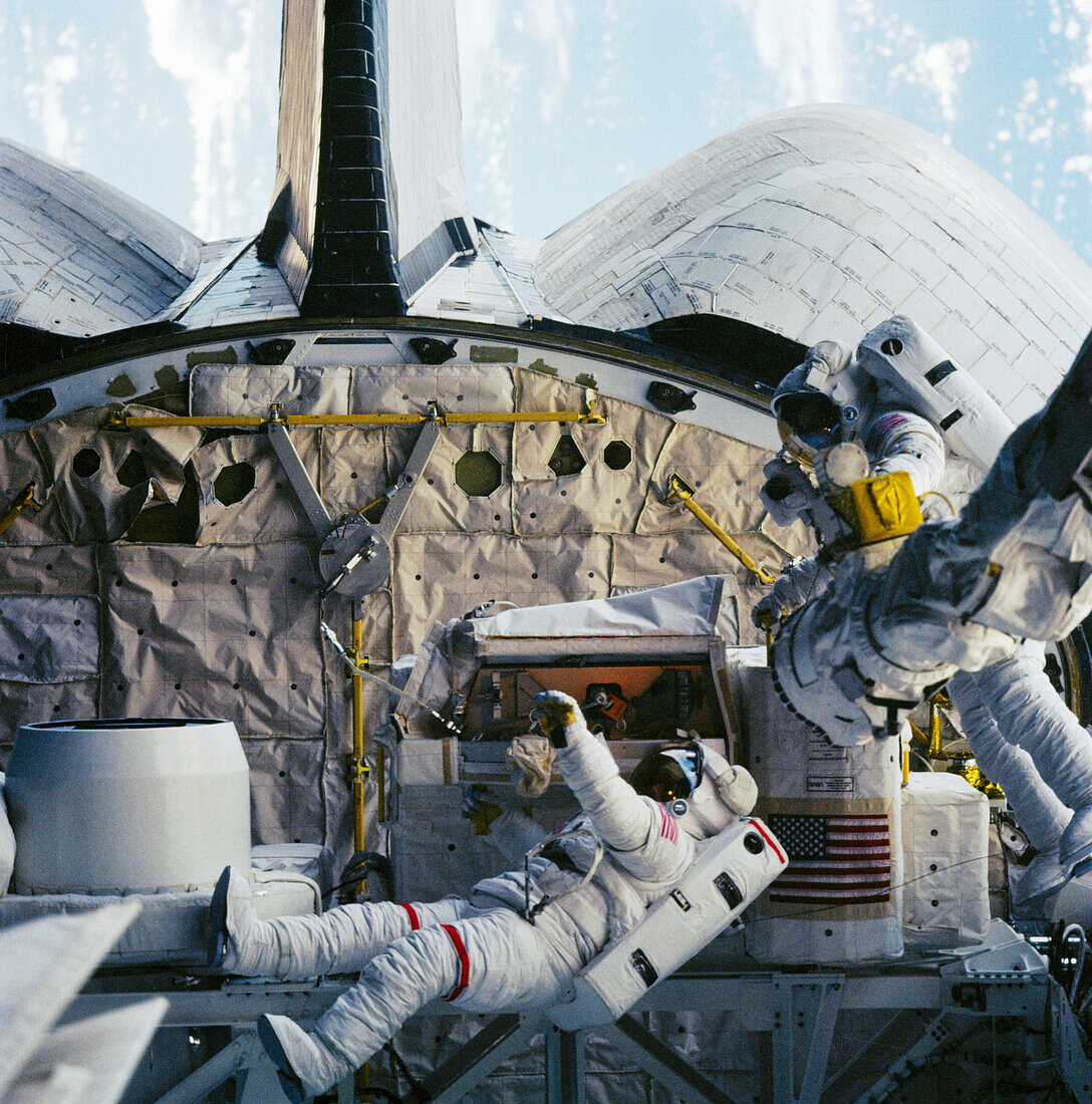 Space shuttle astronauts on a spacewalk