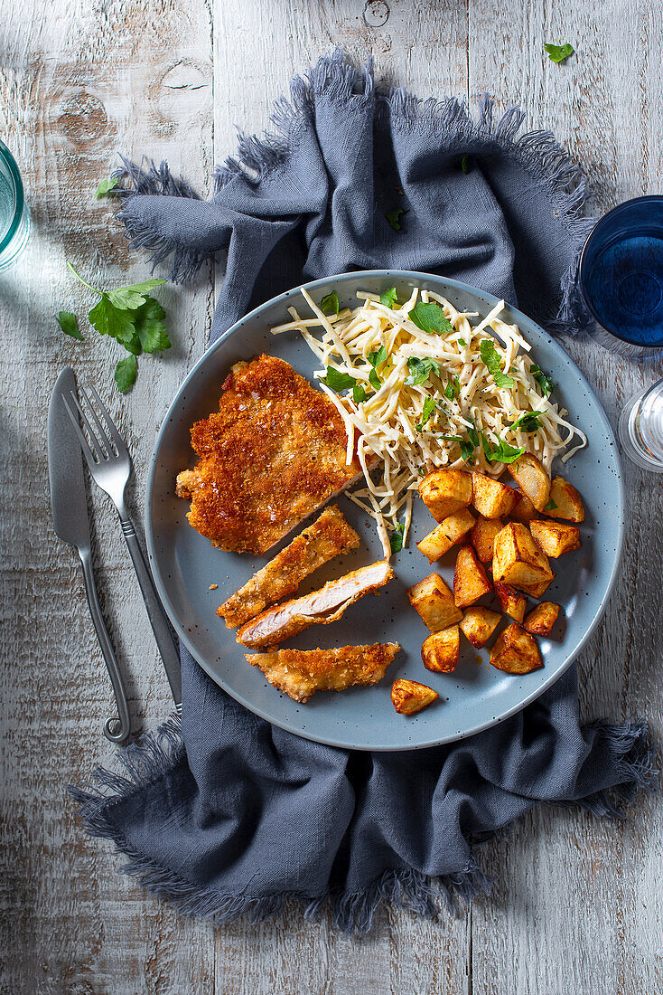 Chicken in breadcrumbs with roasted potatoes, cumin, smoked paprika and celeriac remoulade